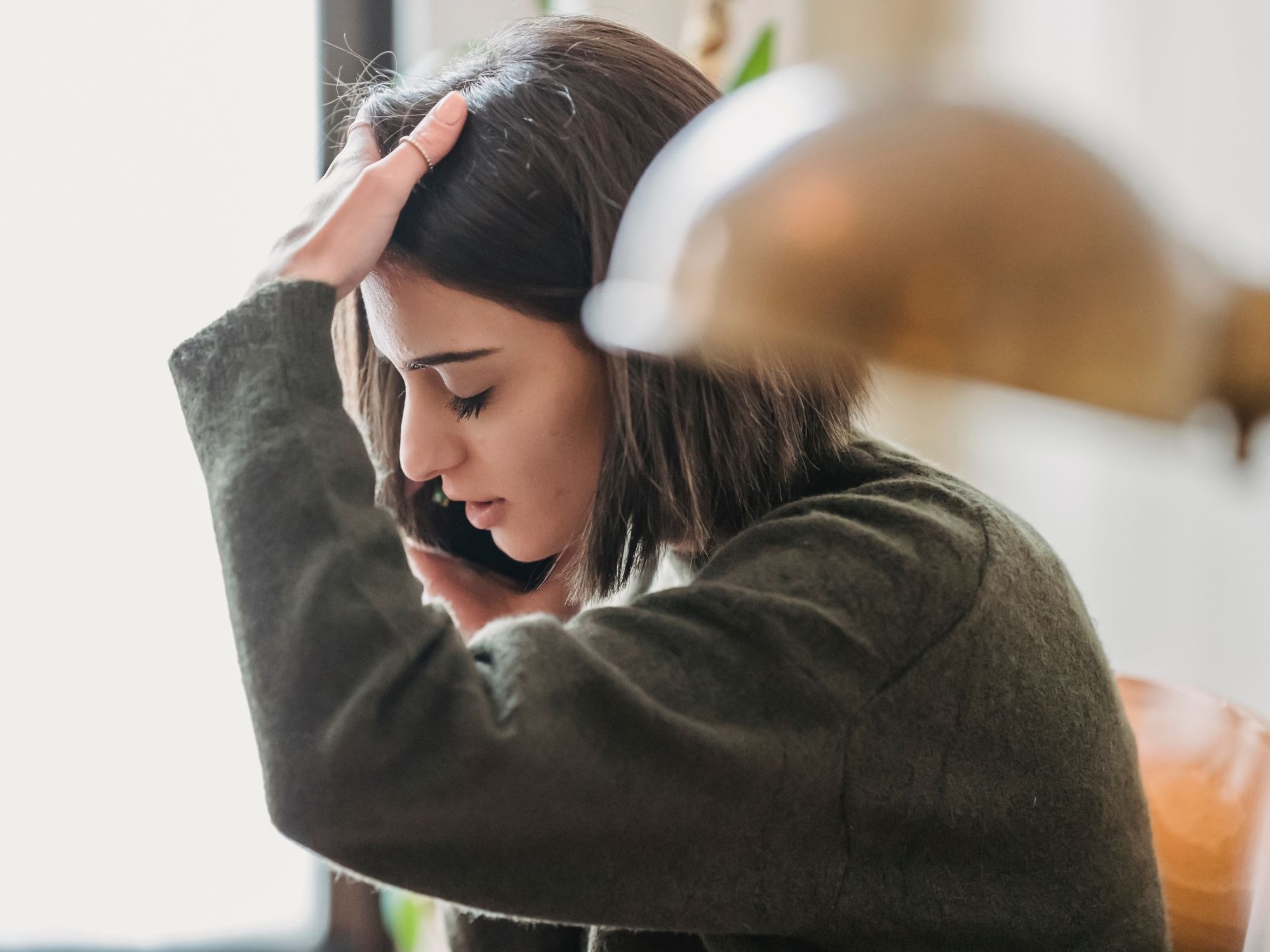 Woman experiencing stress and tension - nervous system balance and stress recovery through Topeka chiropractic care