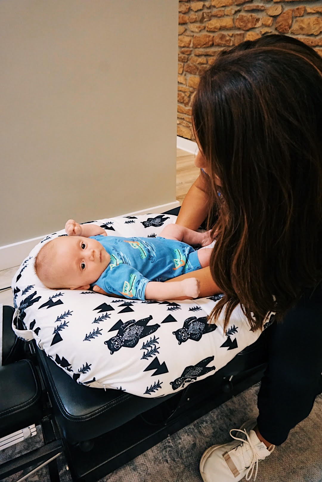 Topeka chiropractor Dr. Maggie Hunsicker providing gentle pediatric chiropractic care to infant patient with loving attention