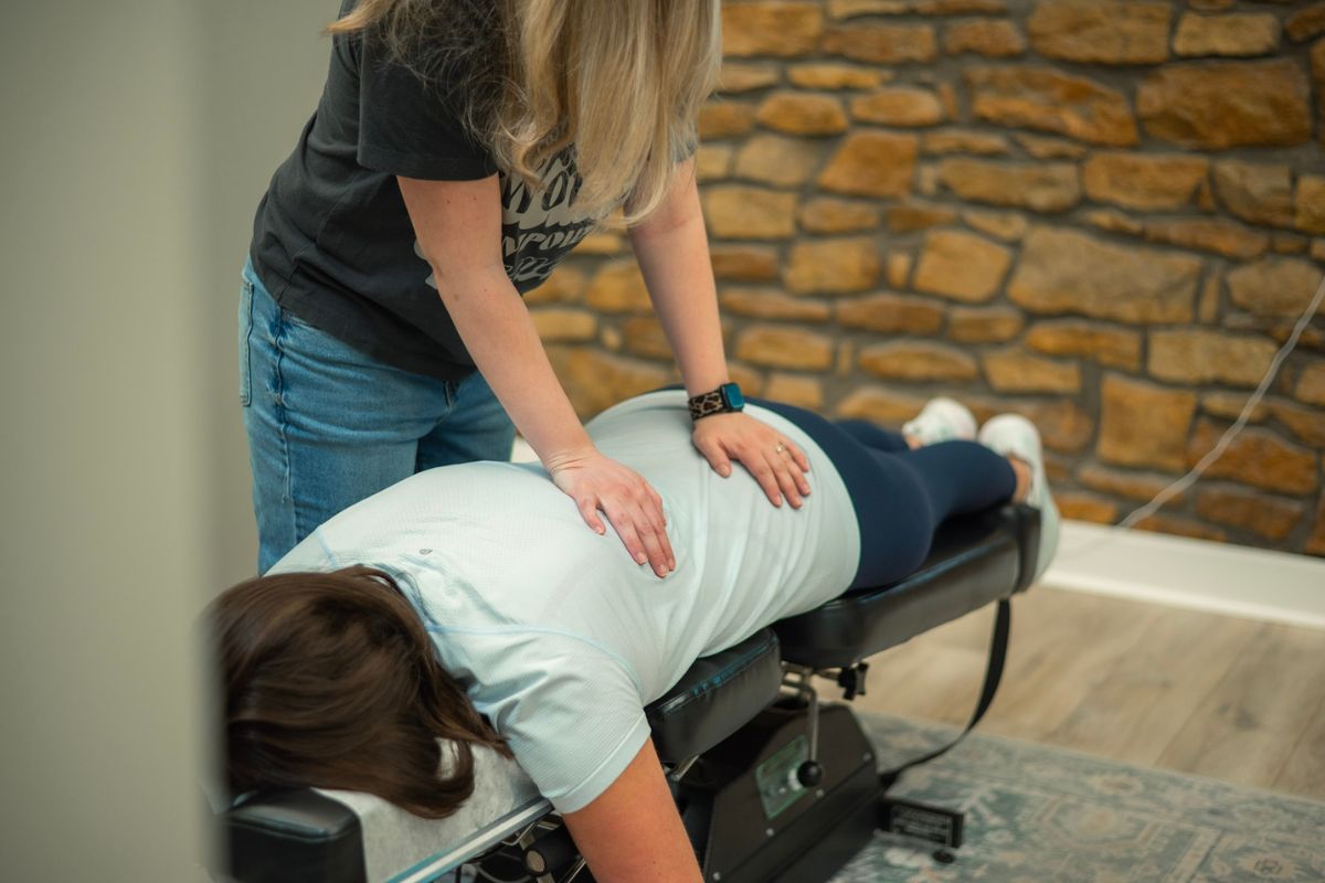 Active adult receiving chiropractic adjustment - athletic performance and injury prevention in Topeka