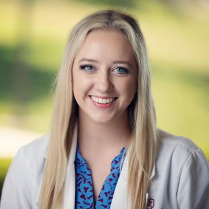 Dr. Maggie Hunsicker consulting with patient at Thrive Chiropractic in Topeka - personalized family wellness care