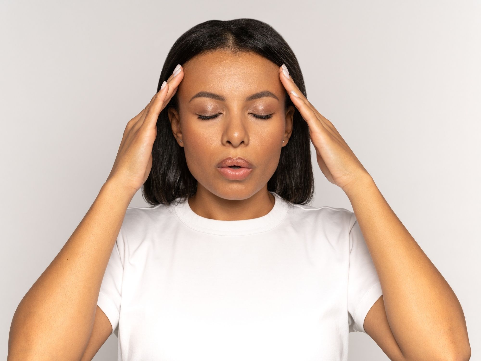 Woman with tension headache and migraine pain - natural headache relief through Topeka chiropractic adjustments